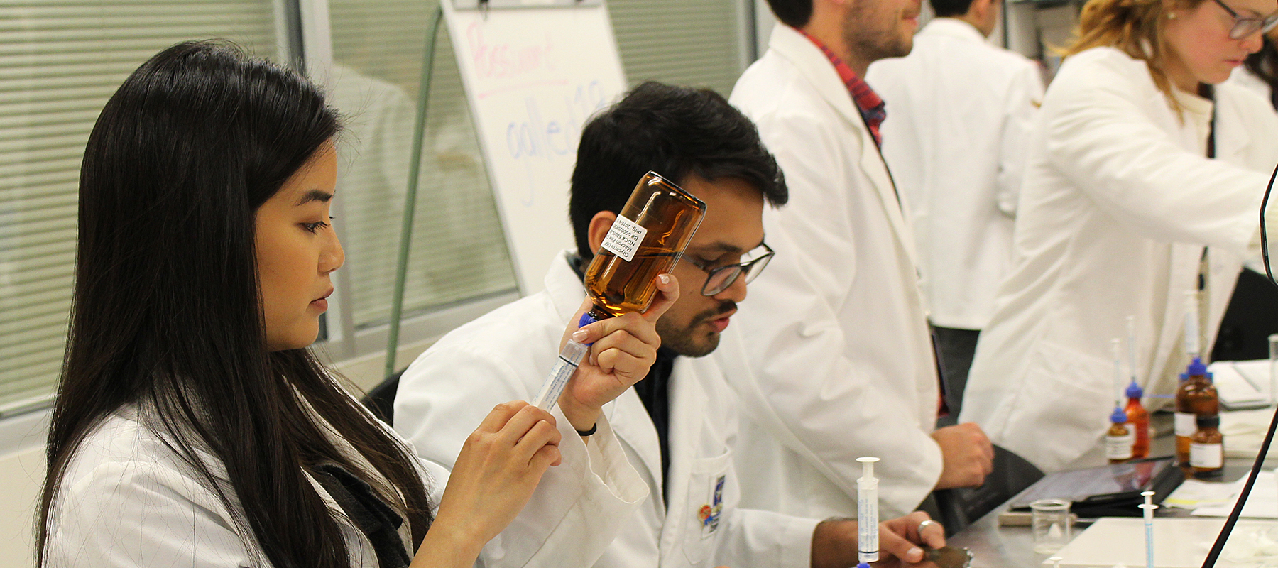 Students working with injections in a lab