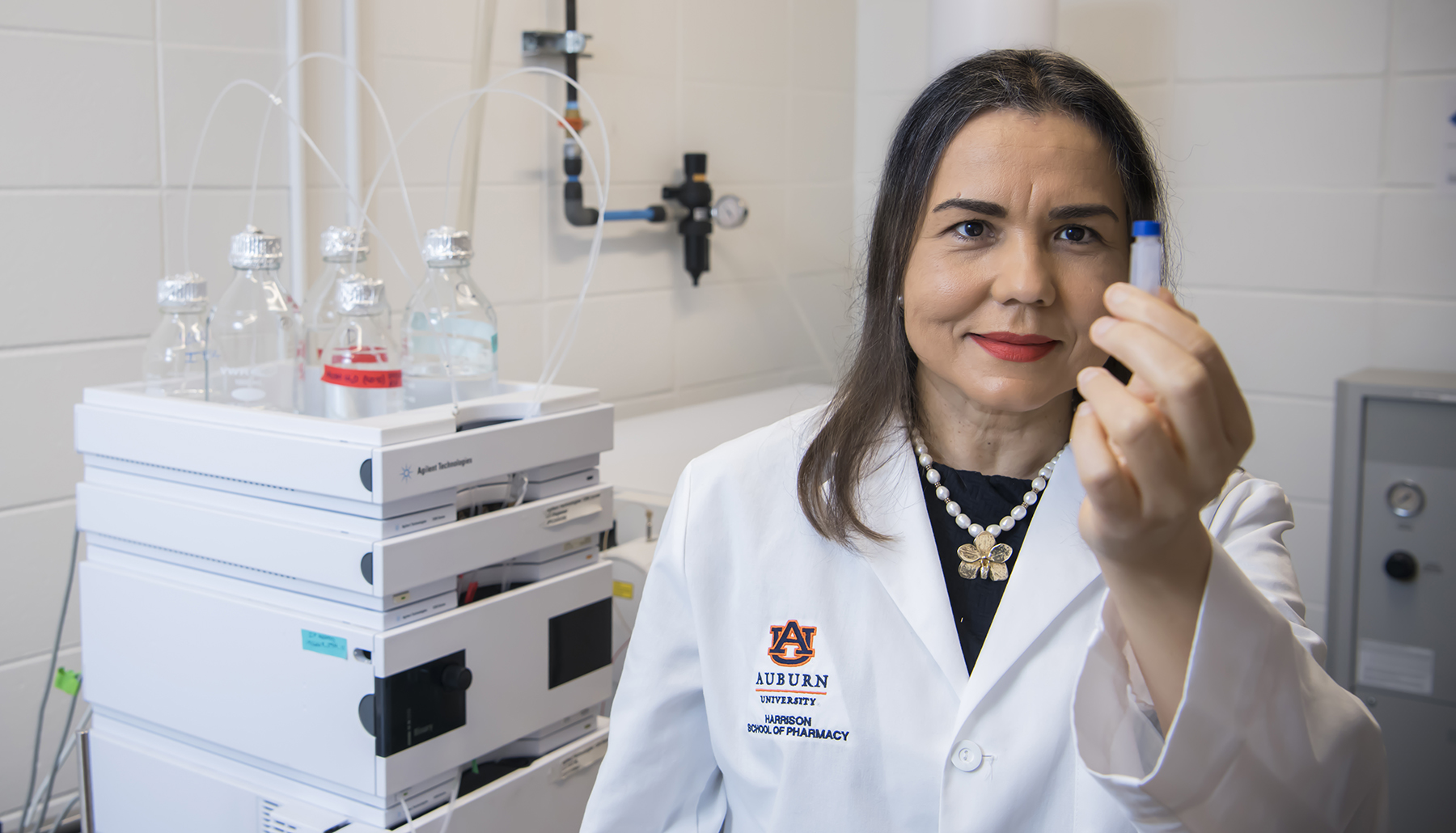 Dr. Calderon holds up a specimen in her lab