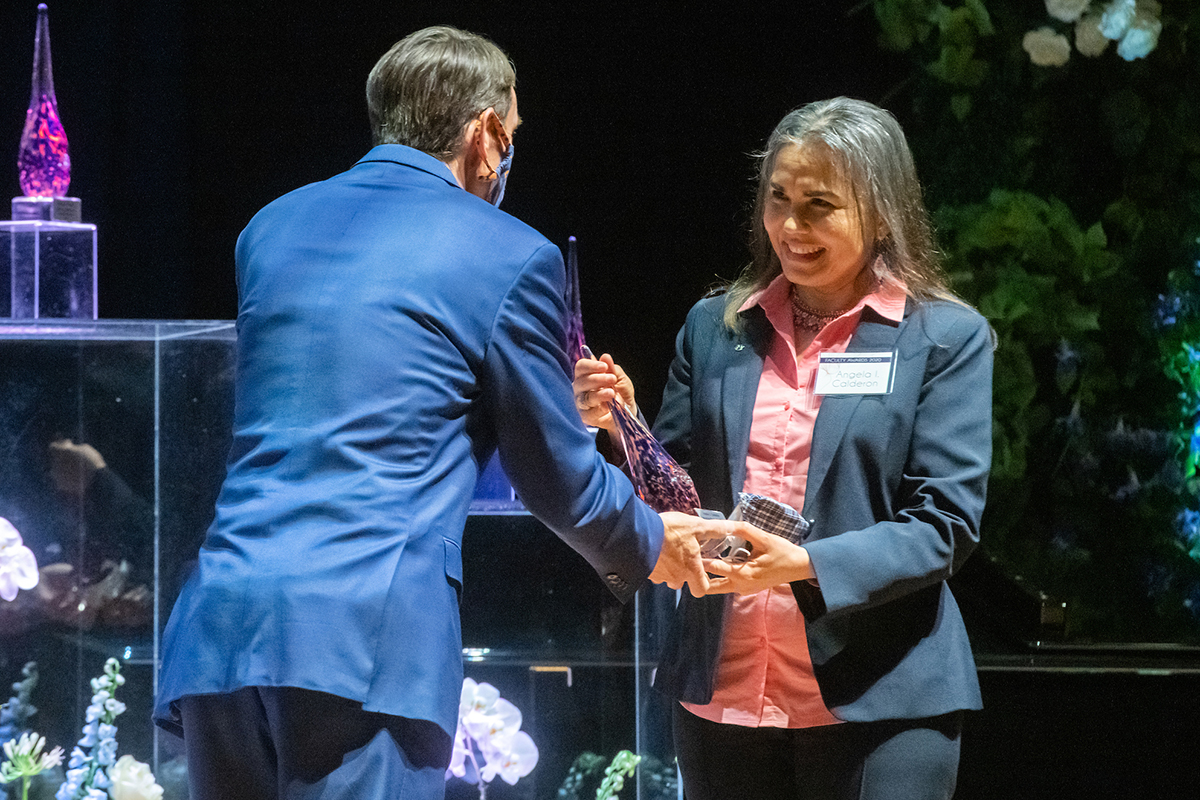 Dr. Calderon receives award from a man