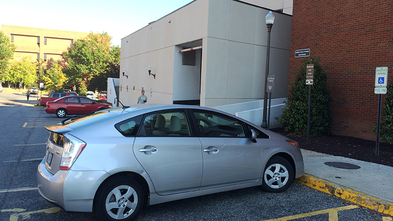 Cars outside entrance to Walker Building